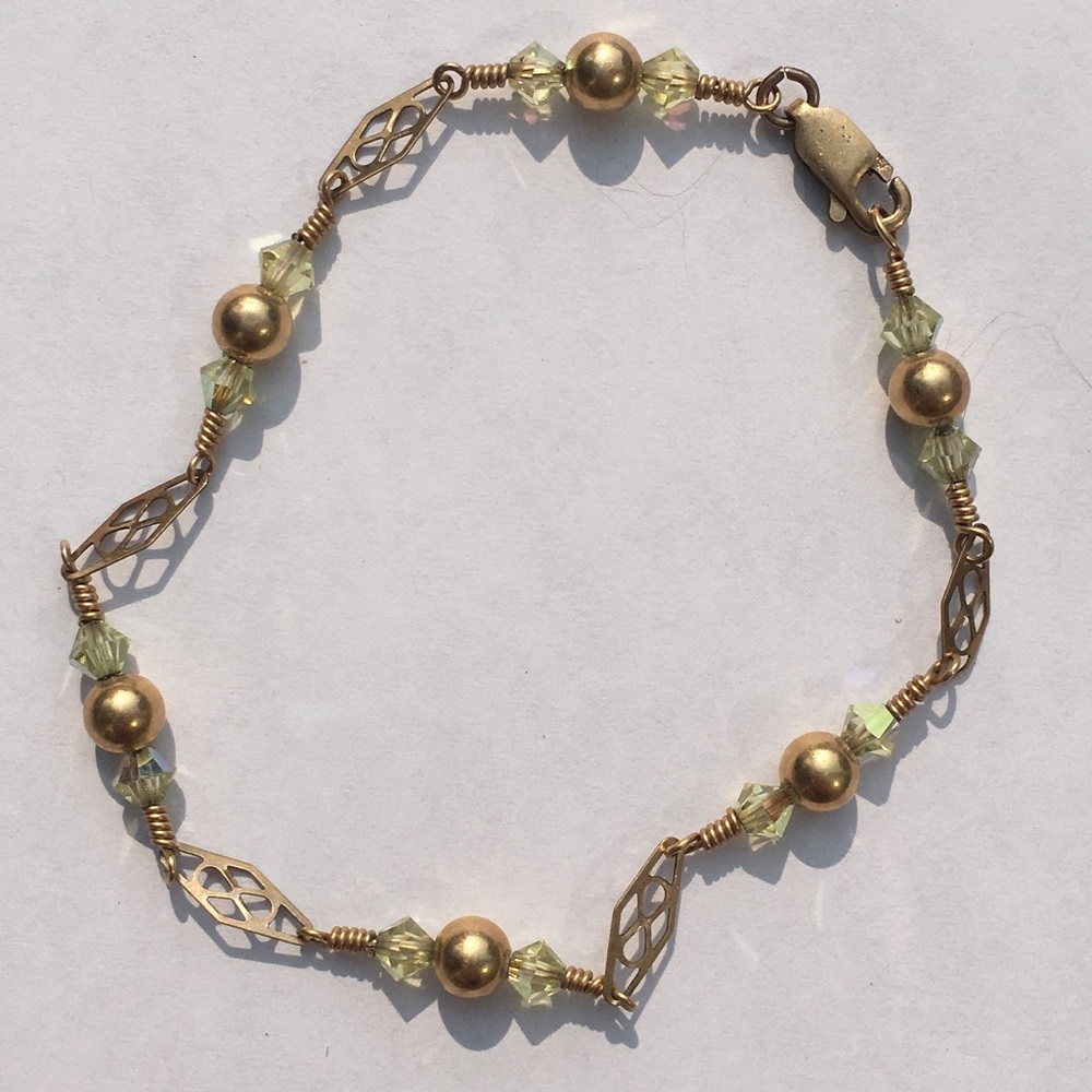 Gold chain bracelet with light green accents